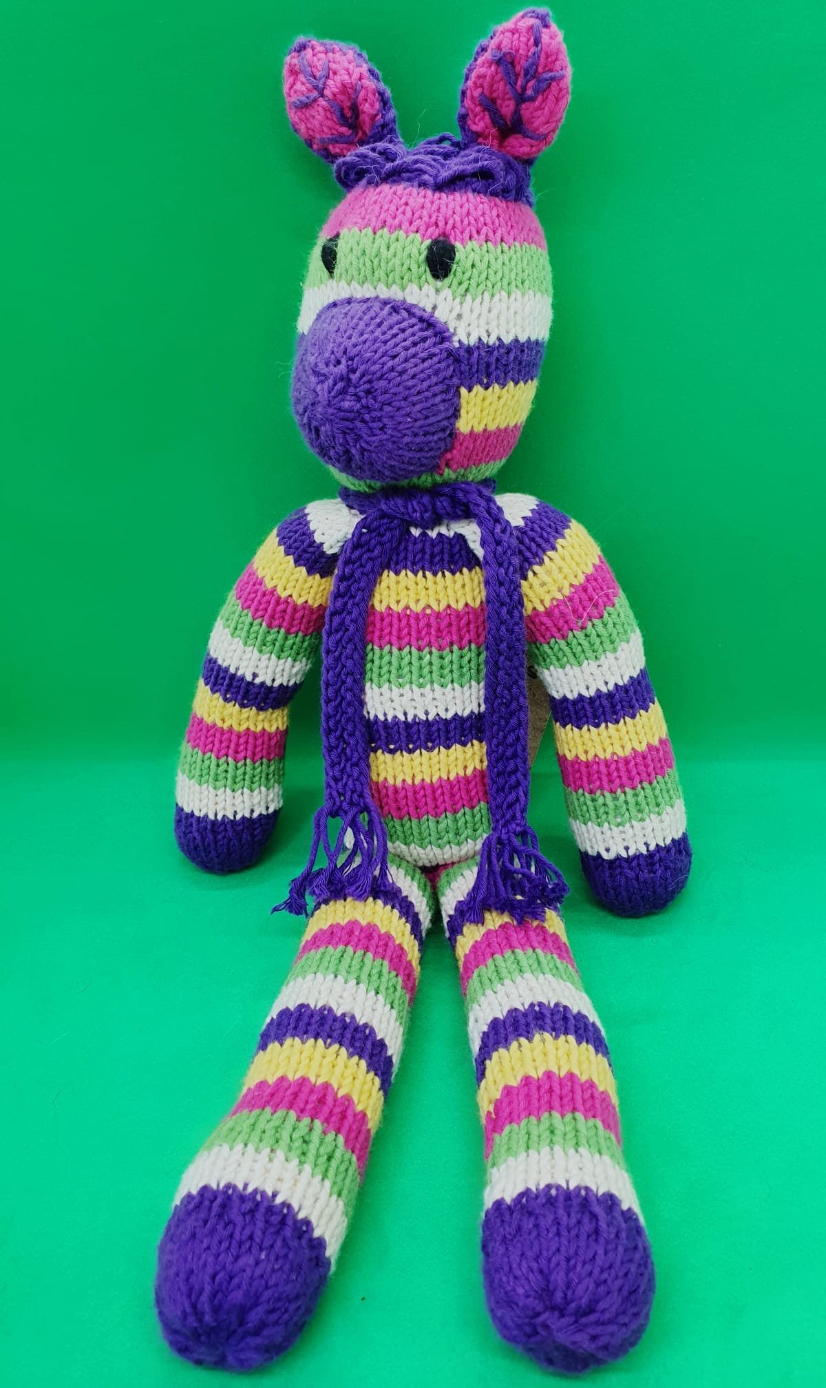 Kenana Knitters, Rainbow Zebra with Purple Scarf