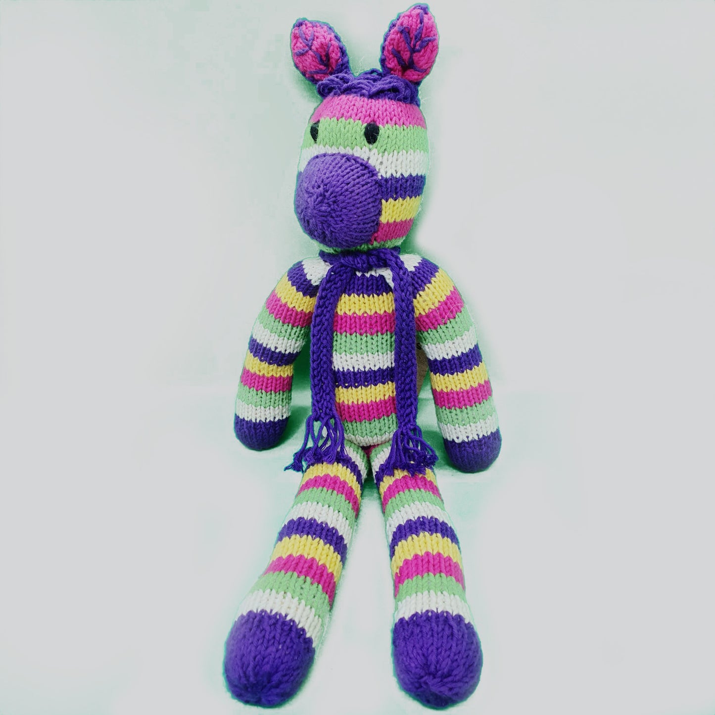 Kenana Knitters, Rainbow Zebra with Purple Scarf